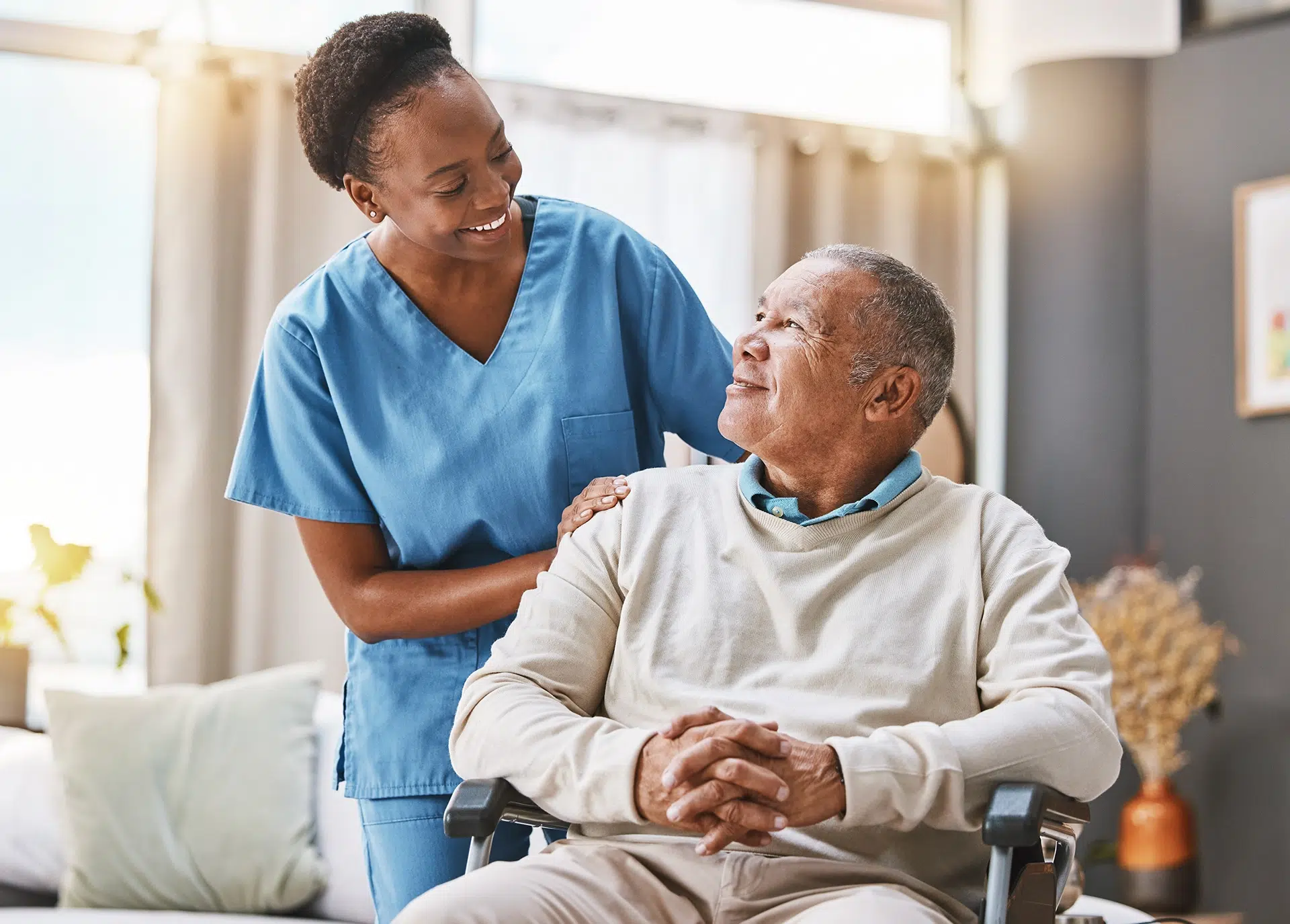 Nurse providing compassionate support to a senior man receiving home care services.