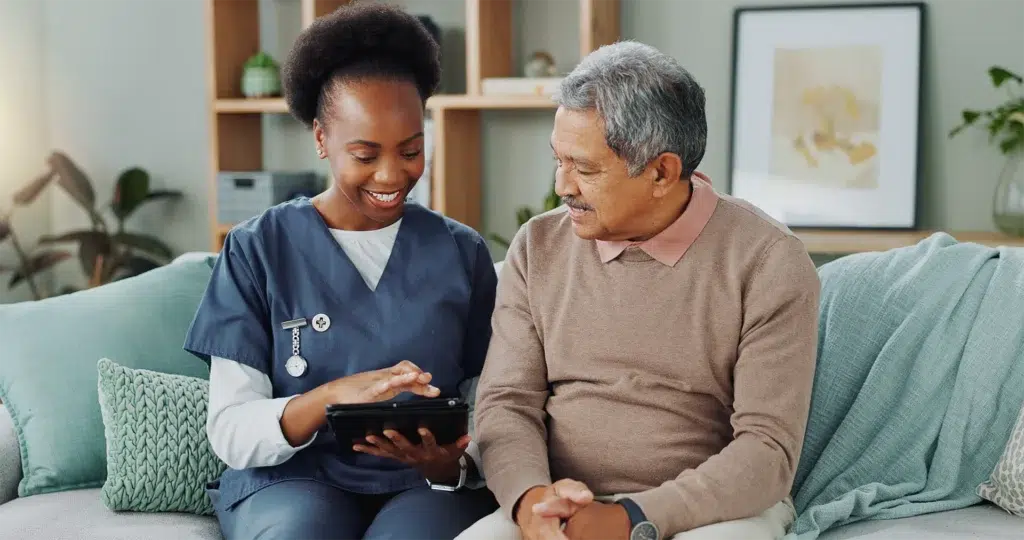 Home health aide assists senior with questions for starting service.
