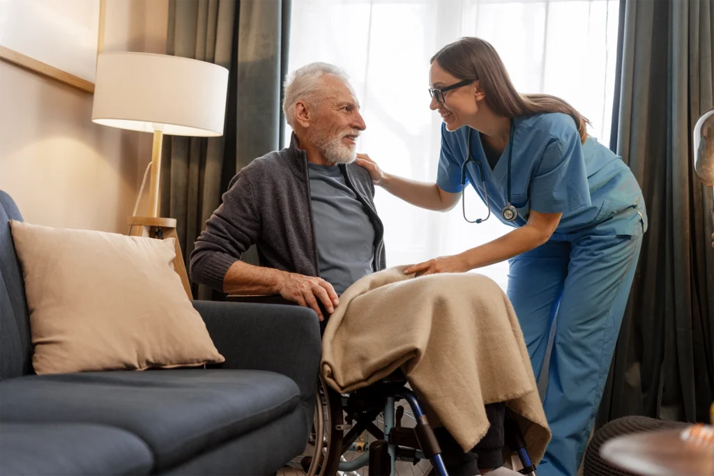 Caregiver providing 24-hour in-home care assistance to a man in a wheelchair at home in Texas