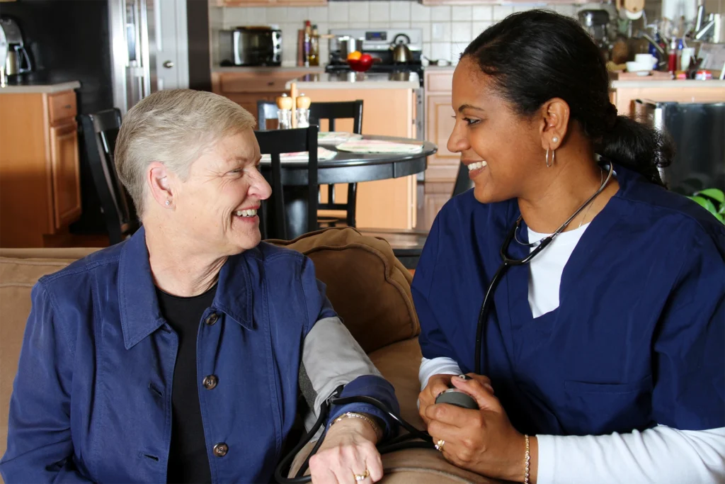 Home health nurse checking blood pressure during in-home senior care visit in Lubbock, Texas